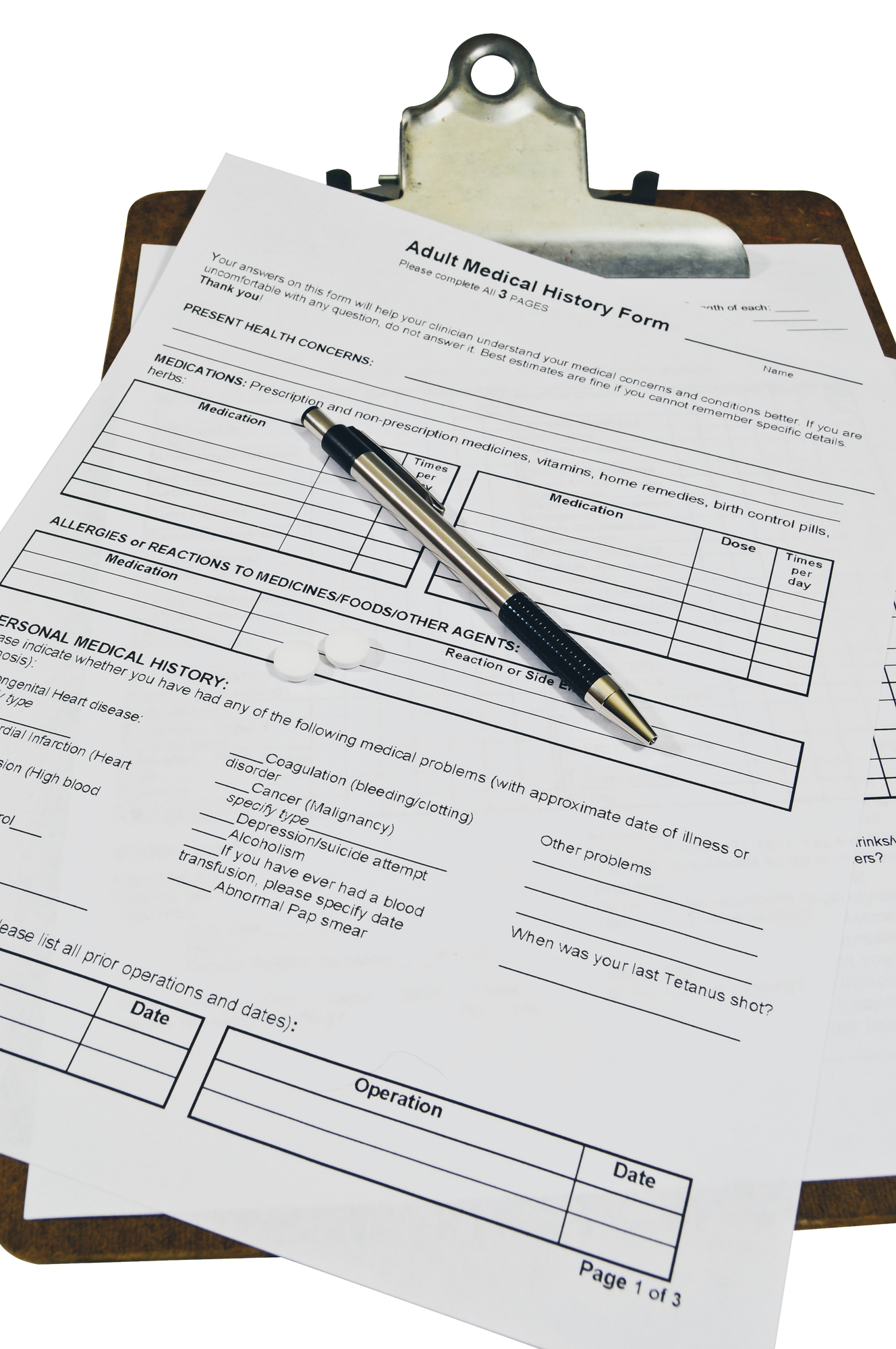 Two white pills and medical history forms