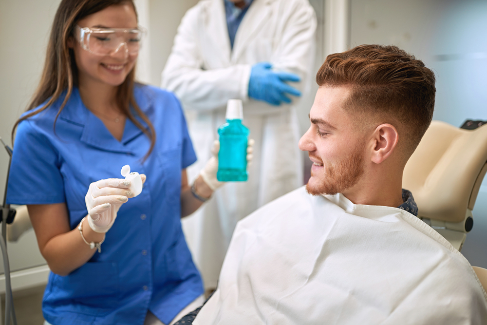 Dentist showing products for oral care